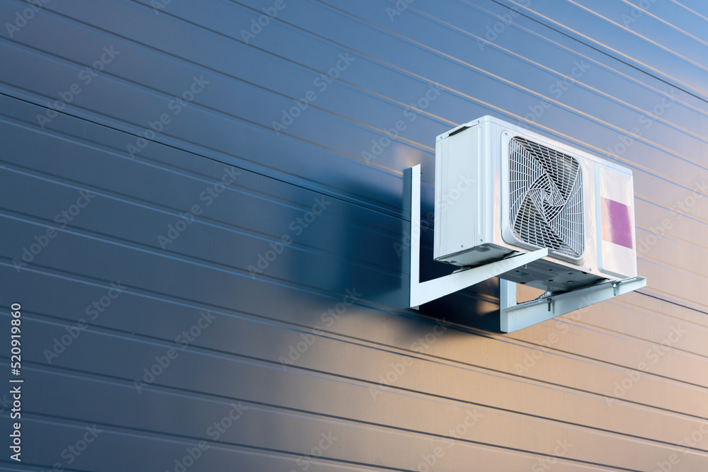 Outdoor split air conditioning units mounted on siding wall Stock Photo ...