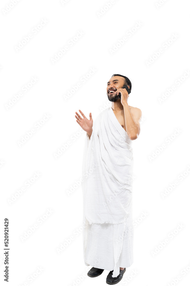 man wearing ihram clothes using smartphone to make a call on white background man wearing ihram clothes using smartphone to make a call on white background