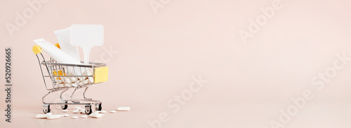 Titanium dioxide, E171, dangerous additive concept. gum, pills, toothpaste, cream in basket and sign with space on beige background. copy space banner photo