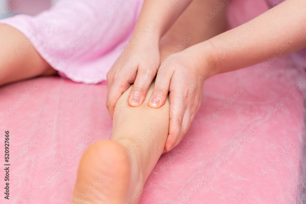 The masseur's hands massage the patient's body. Anticellulite massage. pink background. Soft focus The masseur's hands massage the patient's body. Anticellulite massage. pink background. Soft focus