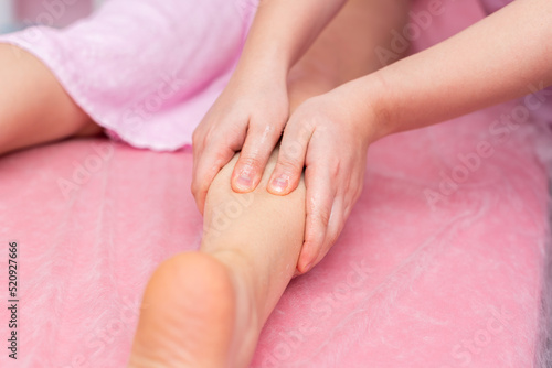 The masseur's hands massage the patient's body. Anticellulite massage. pink background. Soft focus