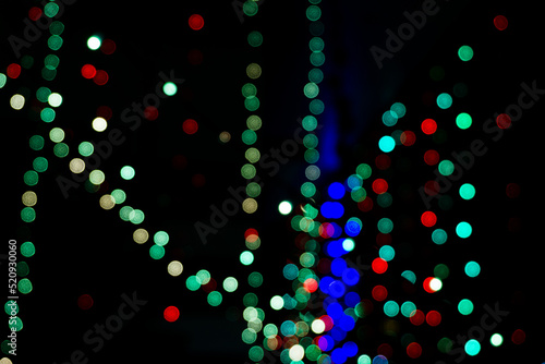 Out of focus bokeh balls of colorful led light with dark background during Diwali festival in India.