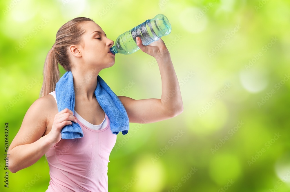 young Woman drinking water from bottle after exercises or sport. young Woman drinking water from bottle after exercises or sport.