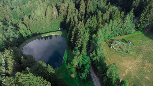 Old ski lift and water reservoar for artificial snow on areh during the summer season. photo