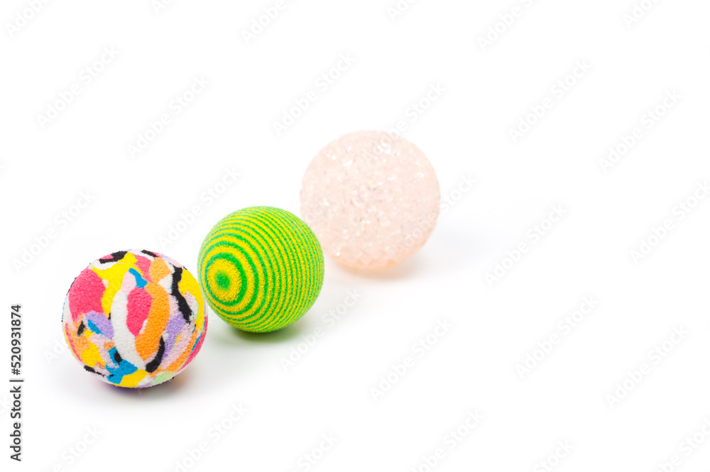 Several plastic and rubber balls for playing with pets.