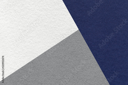 Texture of craft navy blue, white and gray shade color paper background, macro. Structure of vintage abstract indigo cardboard with geometric shape and gradient. Felt backdrop closeup.
