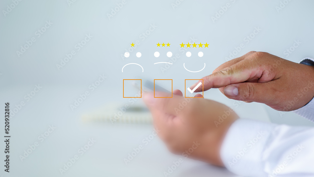 Obraz premium Businessman score 5 virtual stars Satisfaction Assessment Survey Experience feedback business quality, service, service compliments. Best. Five-star rating. service rating Satisfaction Concept.