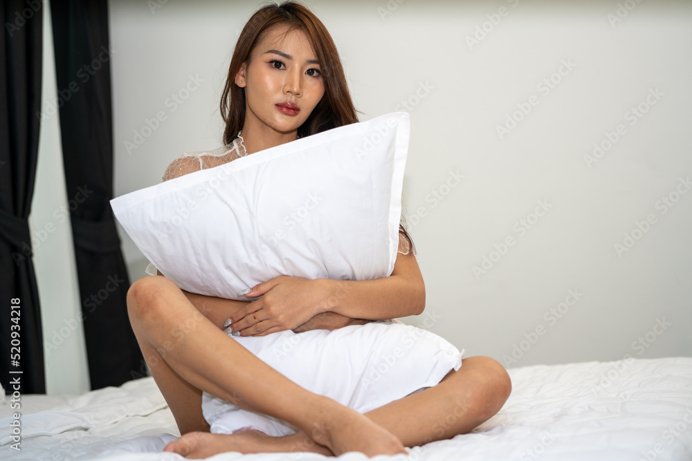 Portrait Young stylish fit slim woman blogger in trendy bikini in her bedroom at home, a slender beautiful woman in white clothes on a dark background outdoors Portrait Young stylish fit slim woman blogger in trendy bikini in her bedroom at home, a slender beautiful woman in white clothes on a dark background outdoors