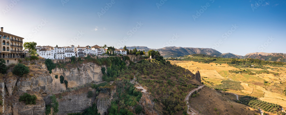 Pano view of Ronda and its surroundings. Beautiful Spanish landscape under a summer morning sky.