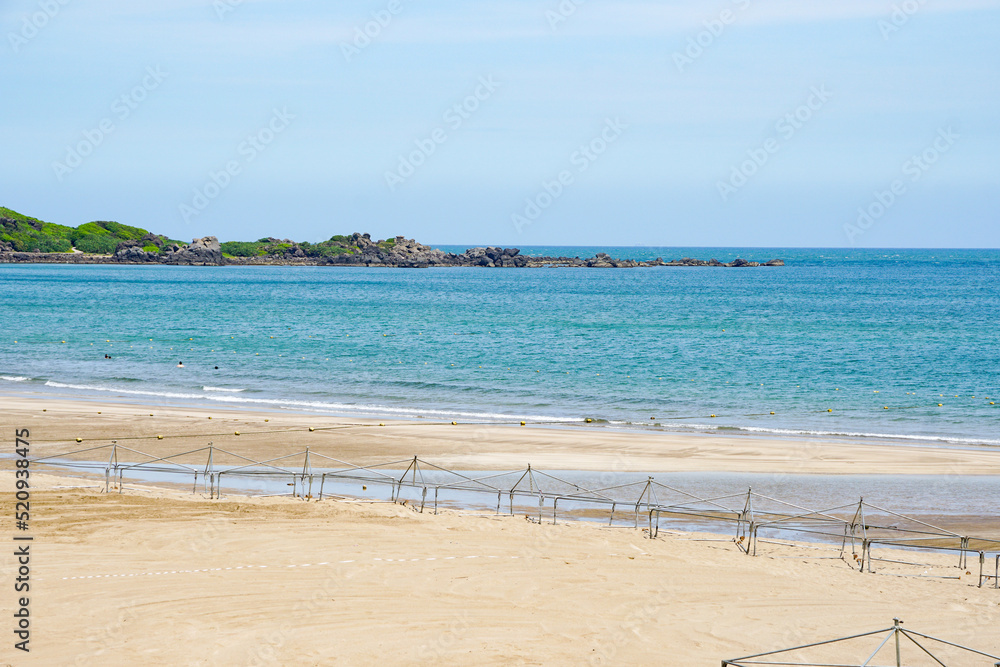 Taipei, Taiwan - July 20, 2022, calm beach by the sea, blue sea without people, sand, rocks
Taipei, Taiwan - July 20, 2022, calm beach by the sea, blue sea without people, sand, rocks