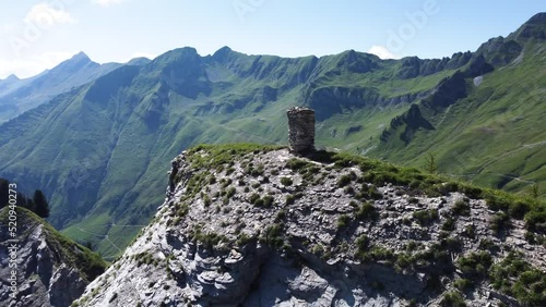 A prayer sculpture located on top of a cliff in the stunning scenery of the Swiss Alps, close to Lake Brienz on a clear blue day in Europe photo