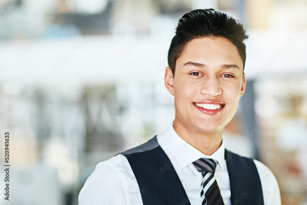Happy, smiling and confident business man standing in a modern office, workplace or at startup company alone. Portrait of the face of a young, cheerful and handsome professional working in corporate Happy, smiling and confident business man standing in a modern office, workplace or at startup company alone. Portrait of the face of a young, cheerful and handsome professional working in corporate
