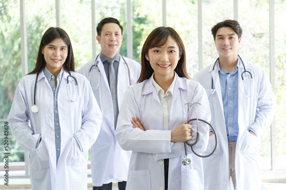 Medicine and healthcare concept : Group of happy and cheerful asian doctors, Male and Female are smiling in lobby of hospital. Medicine and healthcare concept : Group of happy and cheerful asian doctors, Male and Female are smiling in lobby of hospital.