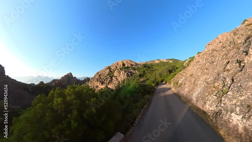 Aerial drone view of the Piana Badlands of Corsica on the D81 route at sunset. Les Calanques of Piana natural park in Mediterranean sea by the Porto Ota town. 360 view of UNESCO heritage photo