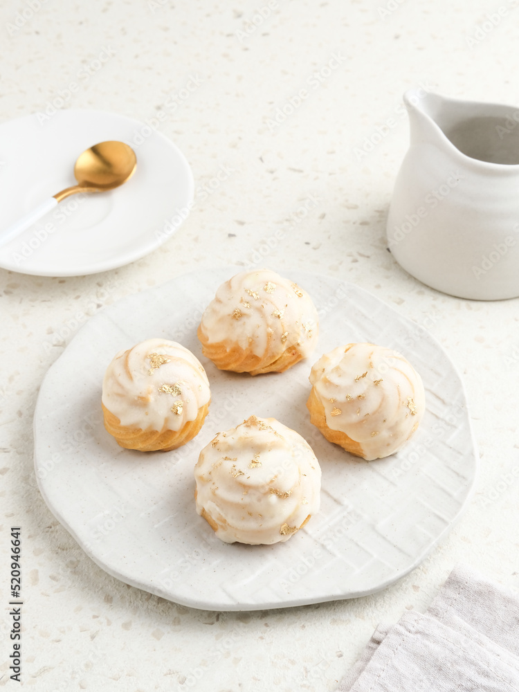 Choux pastry contains butter, water, flour, and eggs. Colorful choux with chocolate glaze. Choux pastry contains butter, water, flour, and eggs. Colorful choux with chocolate glaze.