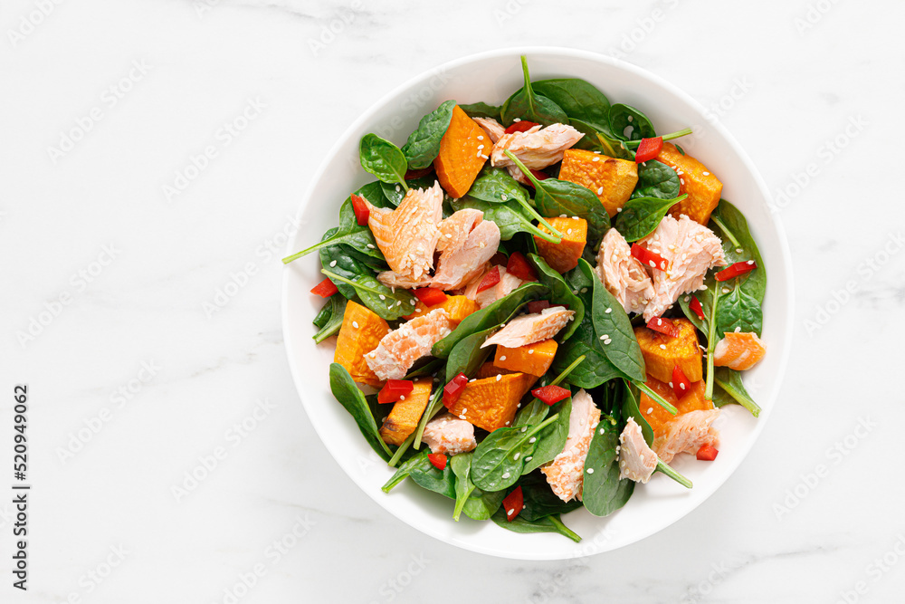Spinach, salmon and sweetpotato festive thansgiving salad with paprika, top view Spinach, salmon and sweetpotato festive thansgiving salad with paprika, top view