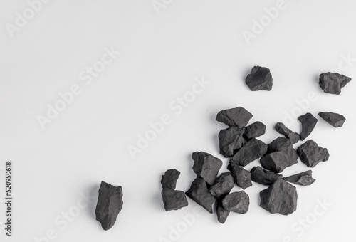 shungite stones on a white background with a copy space