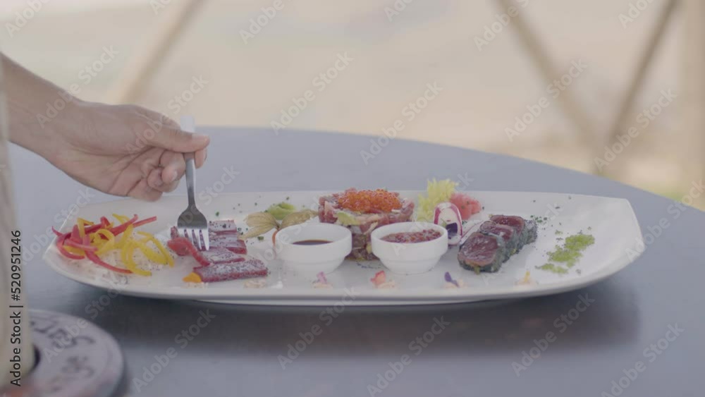 4K SlowMo - Young couple (20-25 years old) having a date in a restaurant gazebo overlooking the beach - cuddling, eating assorted raw tuna, drinking wine, toasting 4K SlowMo - Young couple (20-25 years old) having a date in a restaurant gazebo overlooking the beach - cuddling, eating assorted raw tuna, drinking wine, toasting