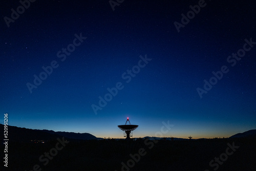 landscape wide shot of Owen Valley Radio Observatory under dark sky and crescent moon