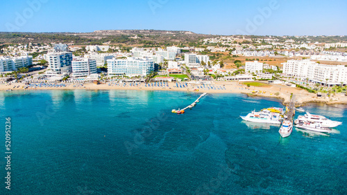 Aerial bird's eye view of Sunrise beach Fig tree, Protaras, Paralimni, Famagusta, Cyprus.The famous tourist attraction family bay with golden sand, boats, sunbeds, restaurants, water sports from above