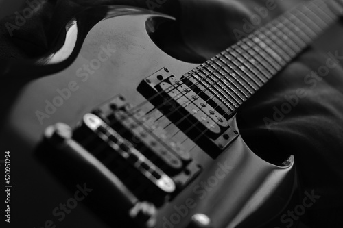 Low key image of an electric guitar in black and white