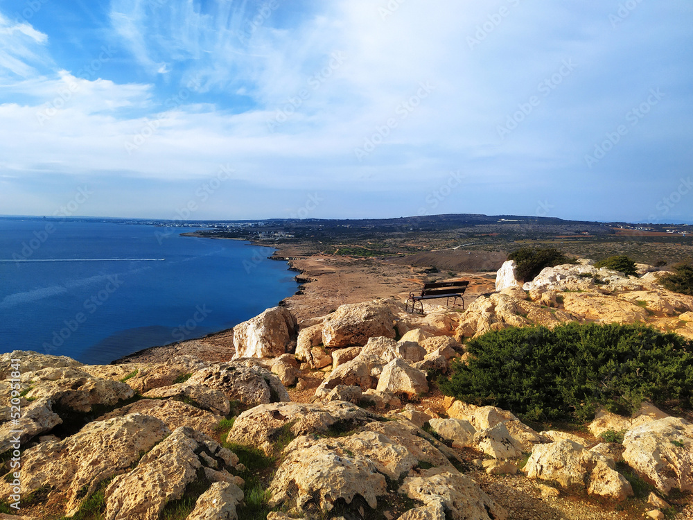 Cape Greco view point near Ayia Napa. A bench on a cliff high above the sea. Travel, relaxation and tranquility concept.