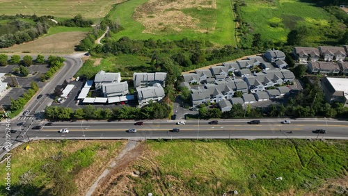 Cars driving on a street passing by one of Whidbey Island's townhouse communities. photo