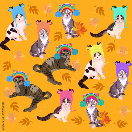 Cute cartoon cats in knitted hats with pom-poms play with autumn leaves isolated on a marigold-colored orange background. Seamless print for fabric, wallpaper, excellent textile for children's jacket.