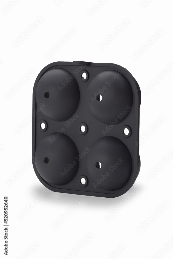 Close-up shot of a black silicone lid for 4 piece ice ball mold. The lid for spherical ice cube mold is isolated on a white background. Back view. Close-up shot of a black silicone lid for 4 piece ice ball mold. The lid for spherical ice cube mold is isolated on a white background. Back view.