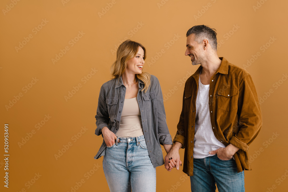White happy woman and man smiling while holding hands White happy woman and man smiling while holding hands
