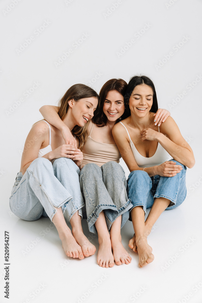 Three gorgeous brunette women posing at camera together Three gorgeous brunette women posing at camera together