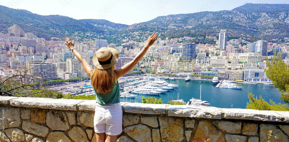 Obraz na płótnie Beautiful panoramic banner view of young woman raising arms on Monte-Carlo cityscape and marina in Monaco w salonie