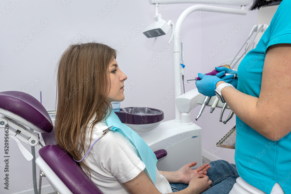 young girl lying in a woman's dentist chair on a dental examination. young girl lying in a woman's dentist chair on a dental examination.