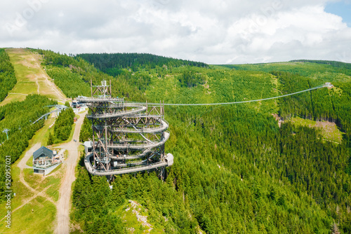Aerial view of the worlds longest 721 meter suspension footbridge Sky bridge and observation tower the Sky walk in the forest, between mountains, Dolni Morava Ski Resort, Czech Republic.  photo