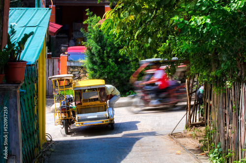 Typical Tricycle Traffic in Puerto Galera on Mindoro, Philippines photo