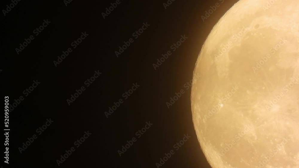 Time lapse of a huge yellow super moon with fast moving clouds during night Time lapse of a huge yellow super moon with fast moving clouds during night