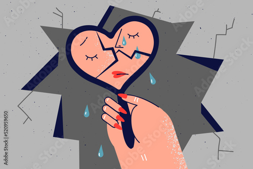Unhappy woman look in broken mirror crying