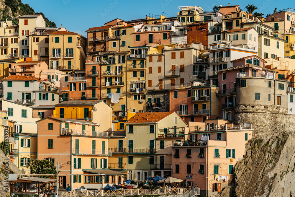 View of Manarola,Cinque Terre,Italy.UNESCO Heritage Site.Picturesque colorful village on rock above sea.Summer holiday,travel background.Italian Riviera landscape.Houses on steep cliff