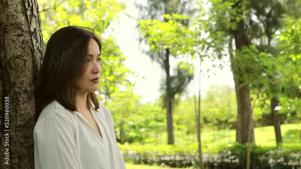 Heartbroken asian woman unhappy sadness in love spends her time alone relax in the garden contemplative,leaning against tree, looking at something around you and calmness giving yourself time.
Heartbroken asian woman unhappy sadness in love spends her time alone relax in the garden contemplative,leaning against tree, looking at something around you and calmness giving yourself time.