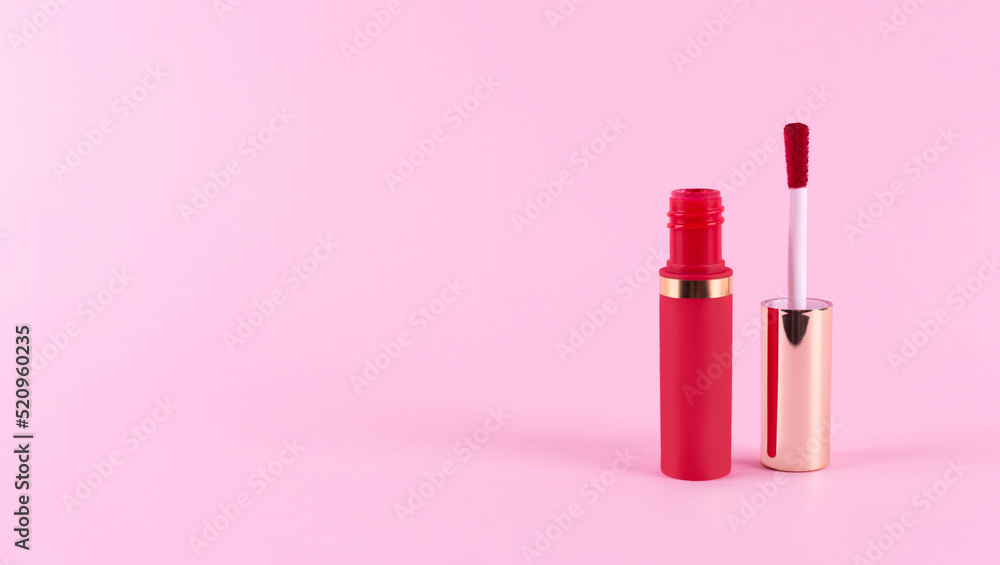 Applicator with liquid perfect red lipstick tube on pastel pink background. Space for text. Mockup and make up concept. Applicator with liquid perfect red lipstick tube on pastel pink background. Space for text. Mockup and make up concept.