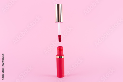 Принти на полотні Lipstick and applicator wand on pastel pink background