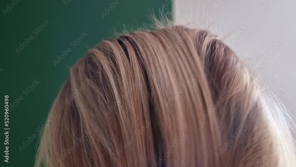 A girl combs her hair with a comb after sleeping or blow-drying A girl combs her hair with a comb after sleeping or blow-drying