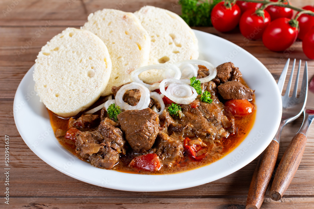 Traditional czech goulash with dumplings on table Traditional czech goulash with dumplings on table