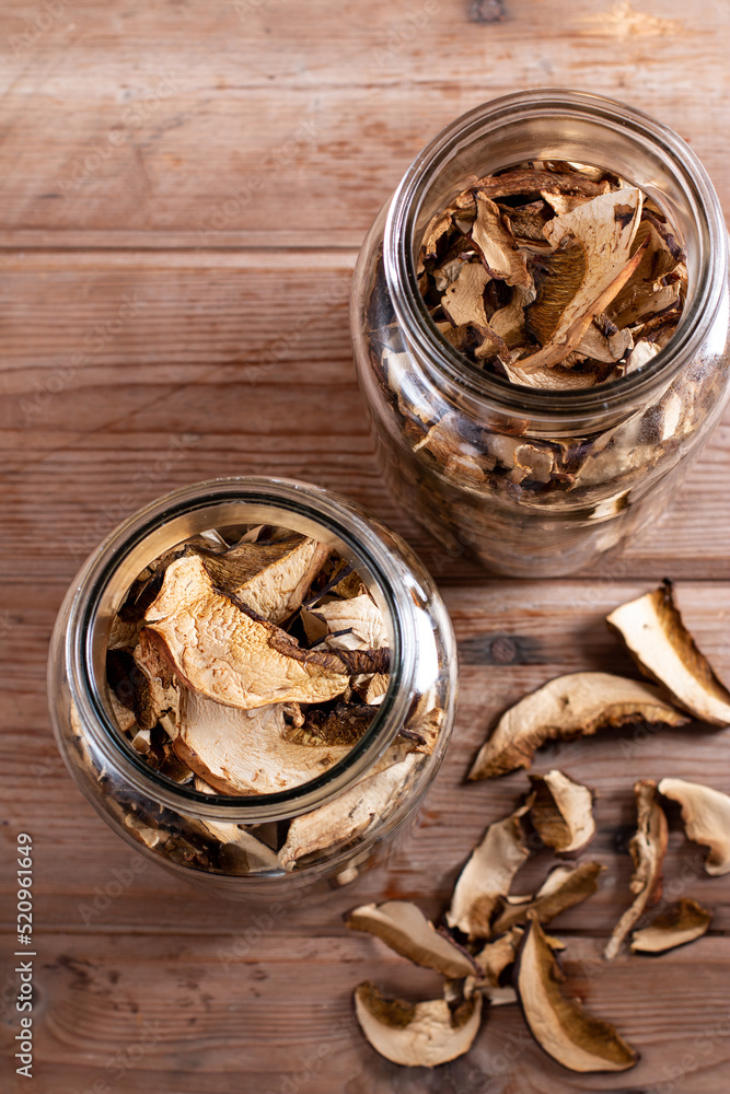 Dried mushrooms. Mushrooms in jar on the wooden table. Top view Dried mushrooms. Mushrooms in jar on the wooden table. Top view