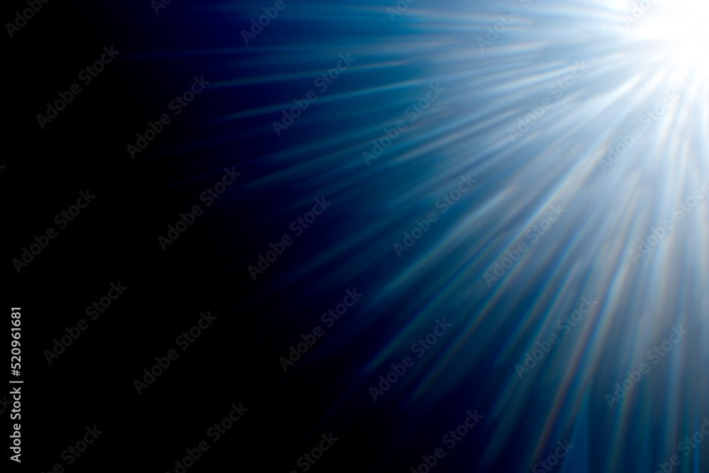Powerful lens flare. Blue flare with rays on dark background.