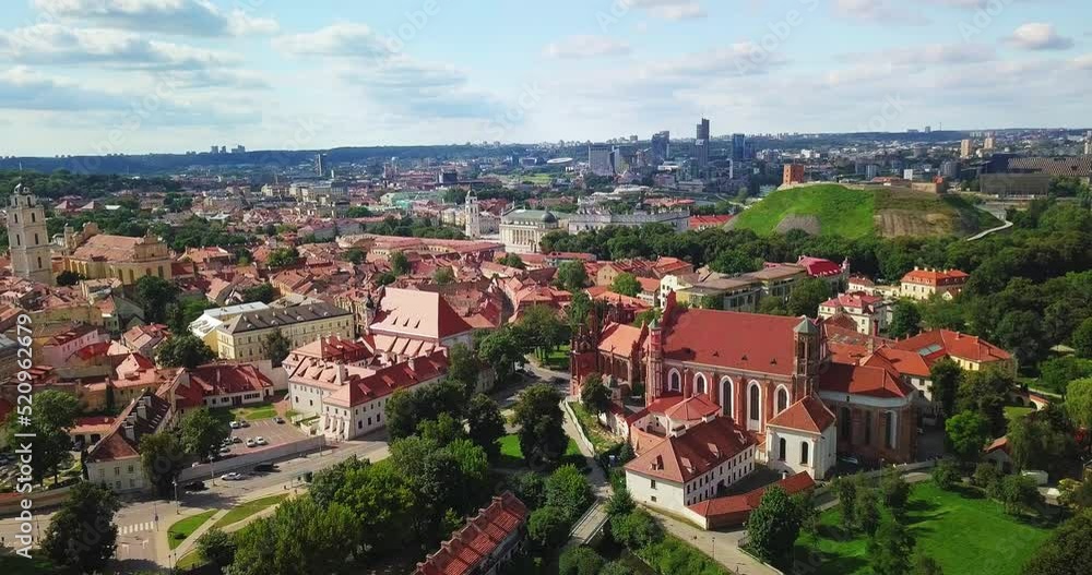Vilnius, Lithuania. Roman Catholic Church Of St. Anne And Church Of St. Francis And St. Bernard In Old Town In Summer Sunny Day. UNESCO World Heritage Vilnius, Lithuania. Roman Catholic Church Of St. Anne And Church Of St. Francis And St. Bernard In Old Town In Summer Sunny Day. UNESCO World Heritage
