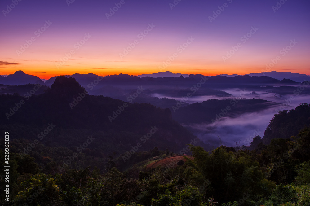 Aerial view Beautiful morning view of sunrise, golden light and mist flowing on the highland fields, Ban Cha Bo, Mae Hong Son,Thailand.