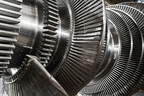 Shiny blades of high-speed steam turbine in workshop photo