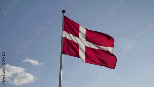 Denmark Flag Waving in the Wind in Slow Motion Close Up with blue sky with clouds background. 4k photo
