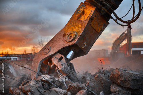 Canvas Print Modern crusher on excavator rigging dismantles concrete beam